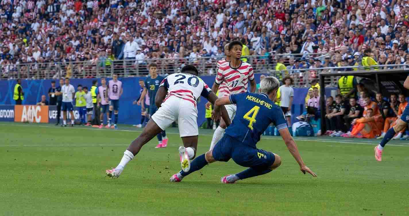 Soccer players clash for possession as a blue defender slides in on a white-red striker amid a crowded stadium.